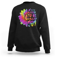 Black sweatshirt with colorful tie-dye sunflower graphic and bold MOM lettering