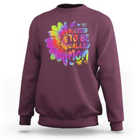Maroon sweatshirt with colorful tie-dye sunflower graphic and bold MOM lettering