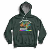 Forest green autism awareness hoodie with colorful gear graphic, front pocket, drawstring