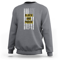 Light gray crewneck sweatshirt with American flag stripes and “BLACK AND PROUD” front graphic