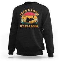 Black sweatshirt with cat reading book graphic and circular text print.