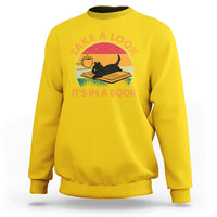 Daisy yellow sweatshirt with cat reading book graphic and circular text print.