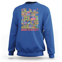Royal blue crewneck sweatshirt with colorful cat-and-bookshelf graphic and text