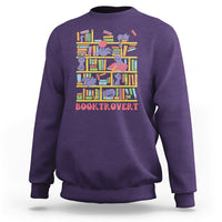 Purple crewneck sweatshirt with colorful cat-and-bookshelf graphic and text