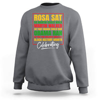 Heather gray crewneck sweatshirt with colorful 'Rosa Sat' and 'Celebrating' front graphic