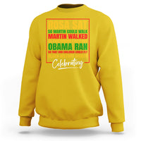 Yellow crewneck sweatshirt with colorful 'Rosa Sat' and 'Celebrating' front graphic