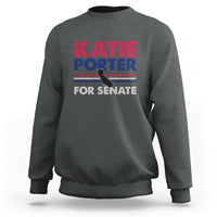 Dark heather crewneck sweatshirt with front graphic text: KATIE PORTER FOR SENATE
