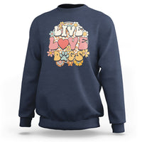 Navy sweatshirt with “LIVE LOVE DOGS” graphic and colorful paw and flower design