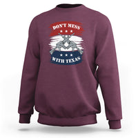 Texas graphic crewneck sweatshirt, maroon, with crossed-guns emblem on chest