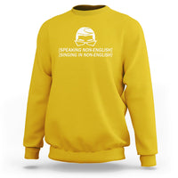 Yellow crewneck sweatshirt with white helmet graphic and speaking/singing text on chest