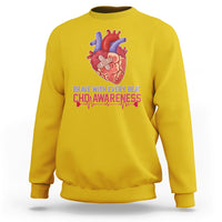 Yellow sweatshirt with red-and-blue heart graphic and CHD awareness text print