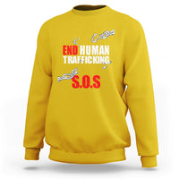 Yellow crewneck sweatshirt with 'END HUMAN TRAFFICKING' and red 'S.O.S.' print