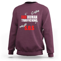 Maroon crewneck sweatshirt with 'END HUMAN TRAFFICKING' and red 'S.O.S.' graphic