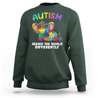 Forest green crewneck sweatshirt with colorful autism graphic and 'Seeing the world differently' print
