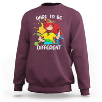 Maroon boys autism awareness sweatshirt with colorful “Dare to be Different” graphic