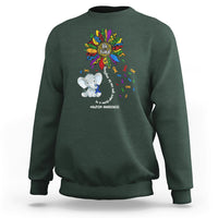Dark green sweatshirt with Be Kind rainbow elephant puzzle awareness graphic