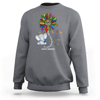 Light gray sweatshirt with Be Kind rainbow elephant puzzle awareness graphic