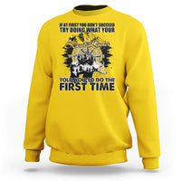 Daisy yellow crewneck sweatshirt with back graphic print and compass-style design.