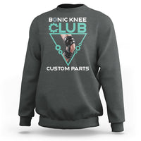 Dark heather crewneck sweatshirt with robotic knee graphic print in teal triangle.