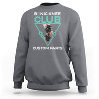 Gray crewneck sweatshirt with robotic knee graphic print in teal triangle.