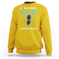 Daisy yellow crewneck sweatshirt with robotic knee graphic print in teal triangle.