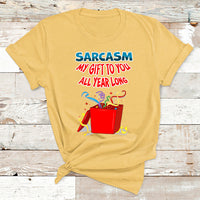 Yellow Christmas T-shirt with colorful 'Sarcasm my gift to you all year long' graphic