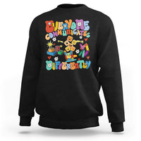 Black crewneck sweatshirt with colorful “Be Different” graphic on chest