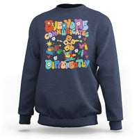 Navy crewneck sweatshirt with colorful “Be Different” graphic on chest