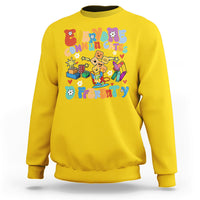 Yellow crewneck sweatshirt with colorful “Be Different” graphic on chest