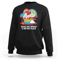 Black sweatshirt with colorful rainbow baker graphic and “Bake the World” text