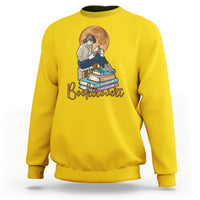 Daisy yellow women’s sweatshirt with front “Booktrovert” graphic of reader and stacked books