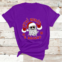 Christmas graphic T-shirt, purple, Santa face with “Stay Merry & Bright”