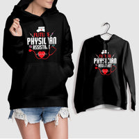 Black hoodie with stethoscope-themed chest graphic, shown on hanger and model