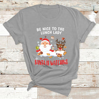 Gray Christmas T-shirt with Santa and reindeer; text reads “Be Nice to the Lunch Lady”
