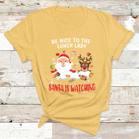 Yellow Christmas T-shirt with Santa and reindeer; text reads “Be Nice to the Lunch Lady”