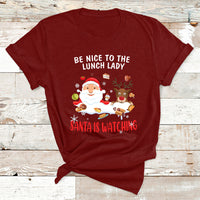 Maroon Christmas T-shirt with Santa and reindeer; text reads “Be Nice to the Lunch Lady”