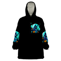 Black wearable blanket hoodie with teal witch skull graphic front and sleeves