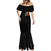 Black off-shoulder mermaid dress with ruffled neckline, skull artwork, and flared hem