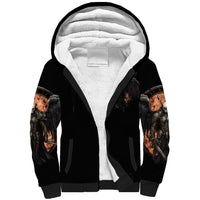 Black sherpa-lined hoodie with skull wings print on sleeves and open hood