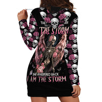 Black hoodie dress with skull-rose print; back reads 'I AM THE STORM'