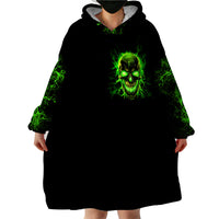 Black hooded wearable blanket hoodie with neon green flame skull graphic and wide sleeves.