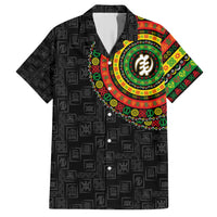Short-sleeve black Hawaiian shirt with colorful circular emblem and repeating symbol pattern