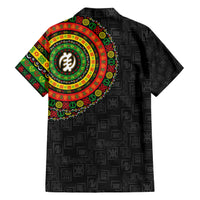 Short-sleeve black Hawaiian shirt with colorful circular print on left chest and symbol pattern