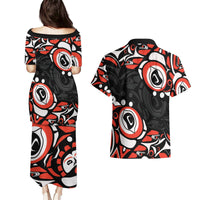 Black off-shoulder puletasi dress with red and white Haida-style circular pattern