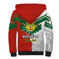 Red sherpa hoodie back with Madagascar text, green flag pattern, baobab silhouettes and hood