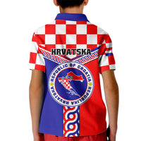 Kids red and white checkered polo shirt, back view, blue crest and ribbon graphic