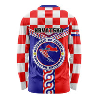 Red long-sleeve shirt back with circular crest and blue panel with Croatian emblem