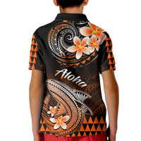 Kids black polo shirt with back swirl shark design, orange triangles, and plumeria flowers