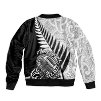 Black satin bomber jacket with white fern and tribal face graphic, ribbed hem