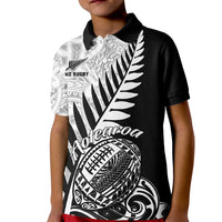 Kids black rugby polo shirt with white Aotearoa fern and tribal graphic on front